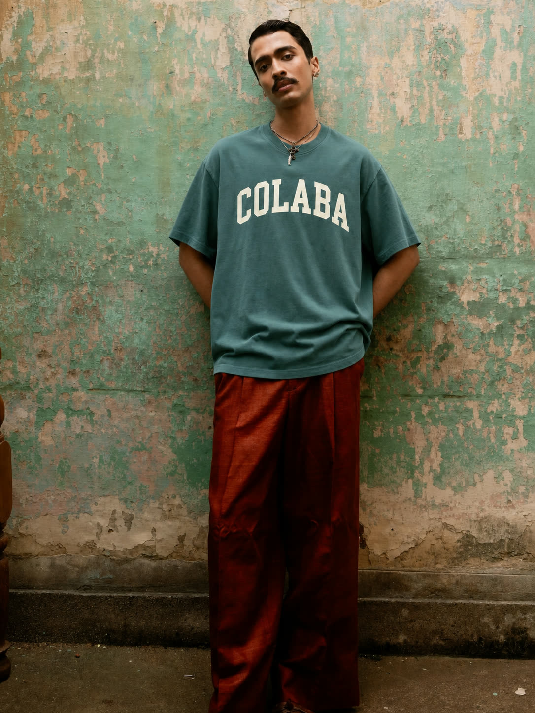 A person against a painted wall in the Colaba tee