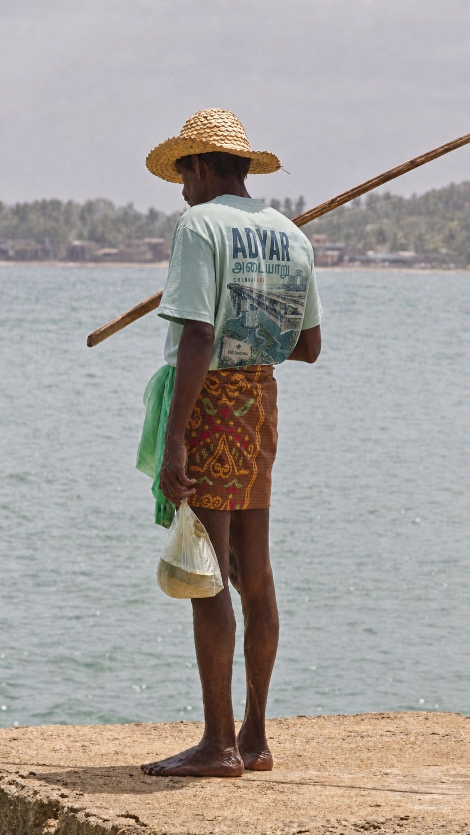 A fisherman in Adyar wearing an Adyar neighbourhood T-shirt